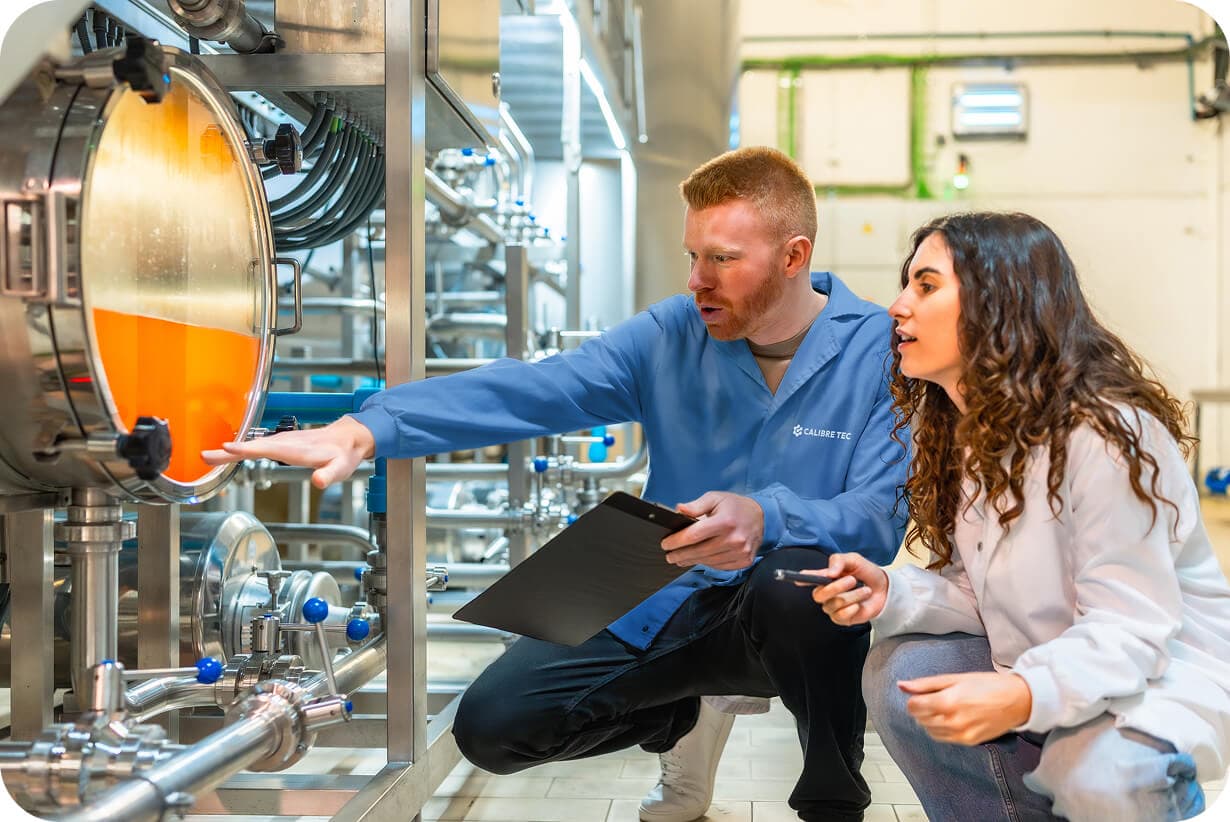 Two technicians examining industrial equipment